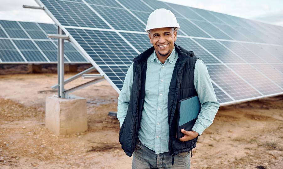 Technician inspecting solar panels on a residential roof in USA