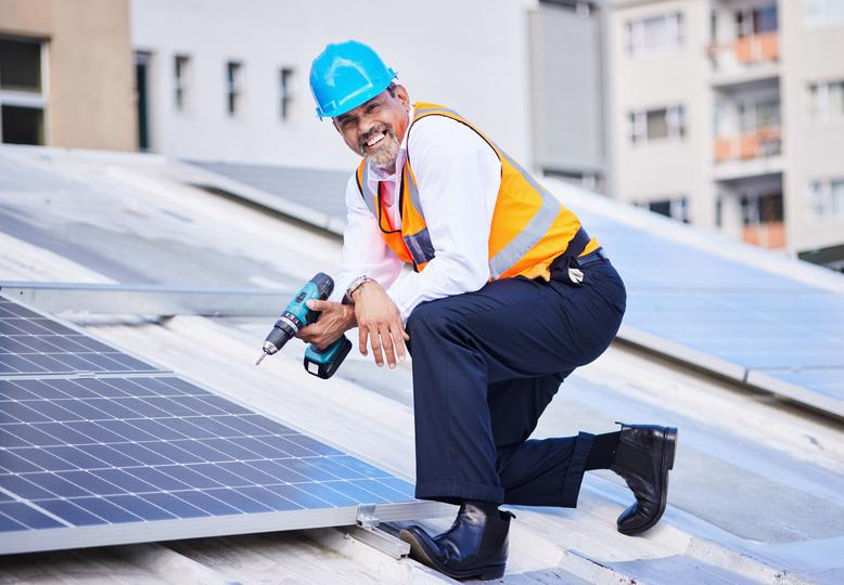 Technician inspecting solar panels on a residential roof in USA